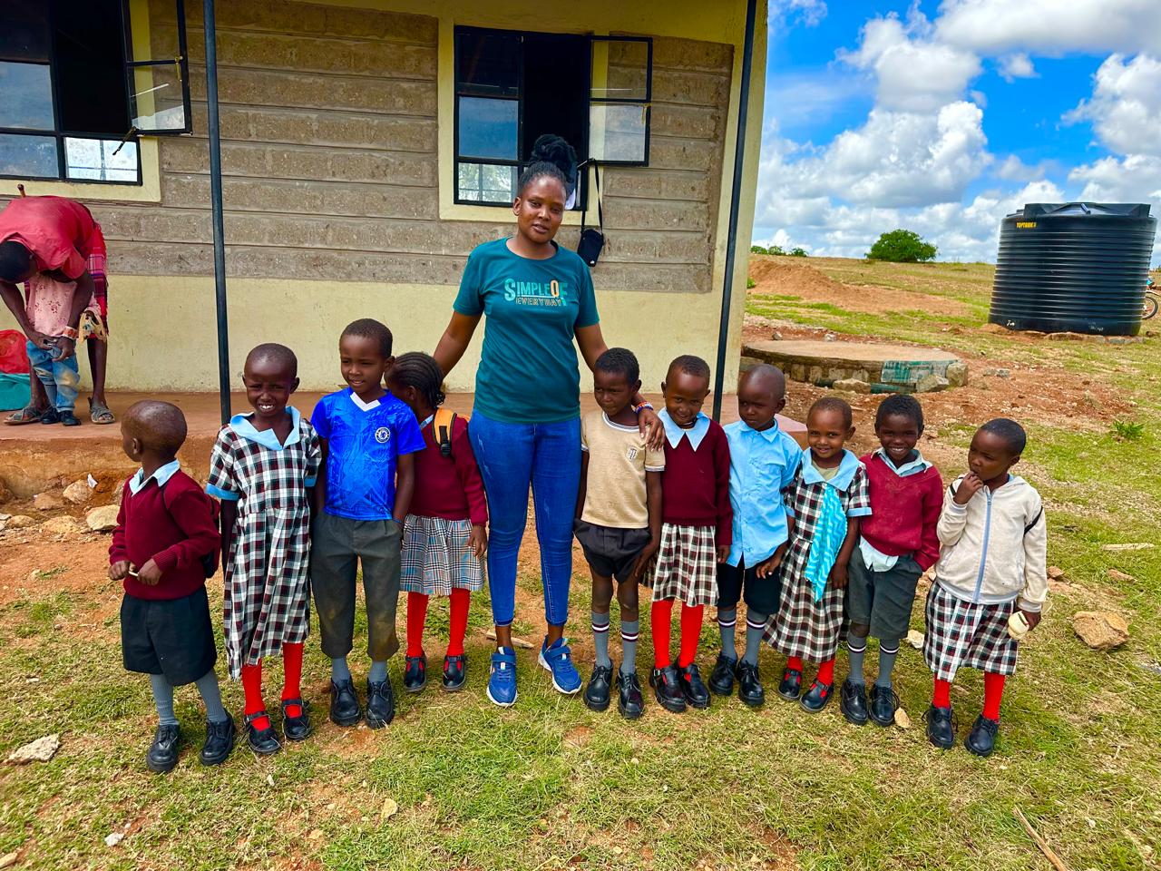 Children in school uniform receiving education support