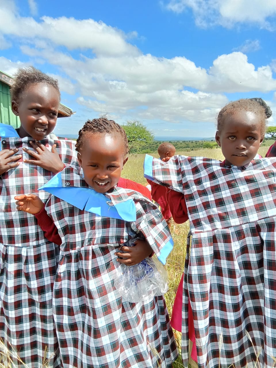 Children receiving uniform support from Engolon Foundation